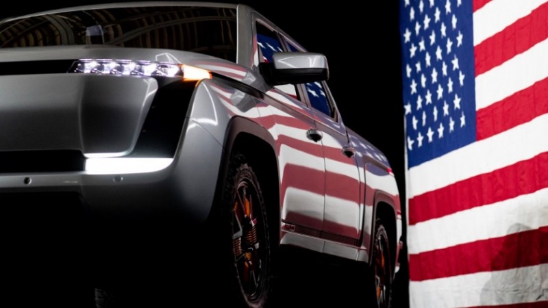 A car parked in front of a flag

Description automatically generated with medium confidence