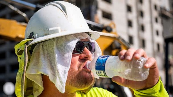 PHOTO: A construction worker drinks to cool down on a hot day in Austin, Texas, on June 27, 2023. (Matthew Busch/The New York Times via Redux)