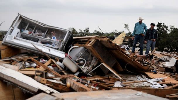 PHOTO: Residents pick up debris after a tornado hit Matador, Texas, U.S., June 22, 2023. (Annie Rice/usa Today Network/VIA Reuters)