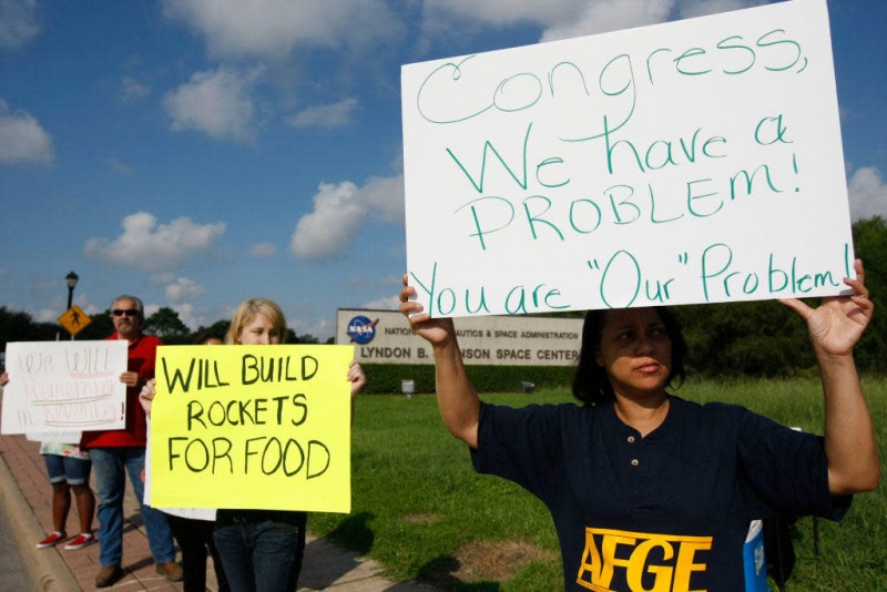 Federal employees express their disappointment with Congress' inability to end the federal government shutdown on Tuesday, Oct. 15, 2013, in Houston. / Credit: Marie D. De Jesus/Houston Chronicle via Getty Images