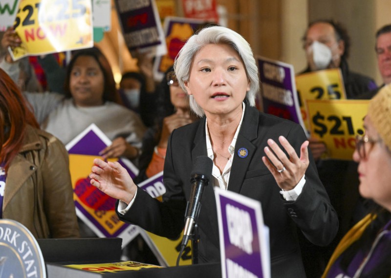 New York Sen. Iwen Chu, D-New York, stands with protesters urging lawmakers to raise New York's minimum wage during a rally at the state Capitol, Monday, March 13, 2023, in Albany, N.Y. (AP Photo/Hans Pennink)